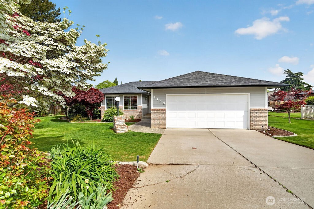 a front view of a house with garden