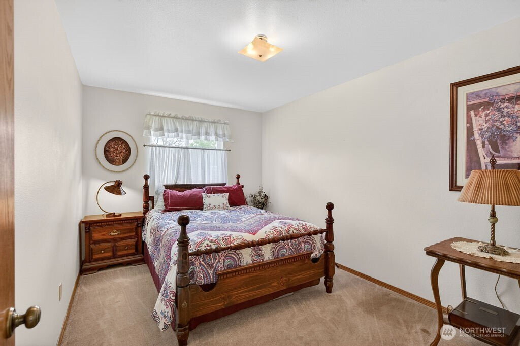 2105 Sutton Place Wenatchee, WA 98801 - Photo 14 of 39 a bed room with a bed and a lamp next to a window