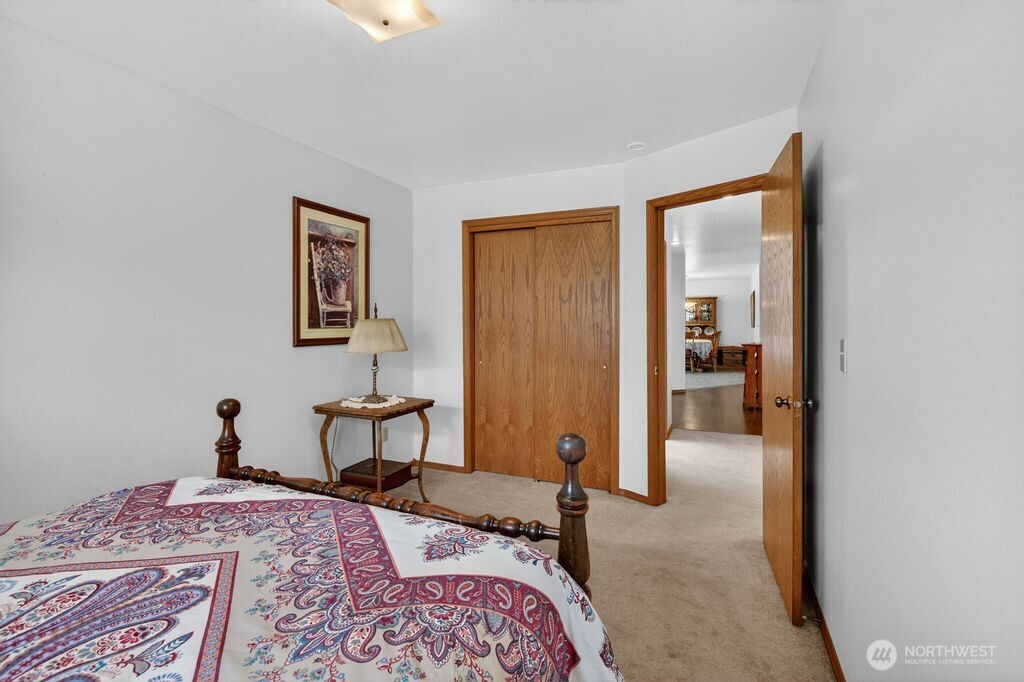 2105 Sutton Place Wenatchee, WA 98801 - Photo 15 of 39 a bedroom with a bed and a chandelier