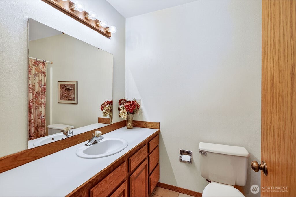 2105 Sutton Place Wenatchee, WA 98801 - Photo 18 of 39 a bathroom with a sink mirror vanity and toilet