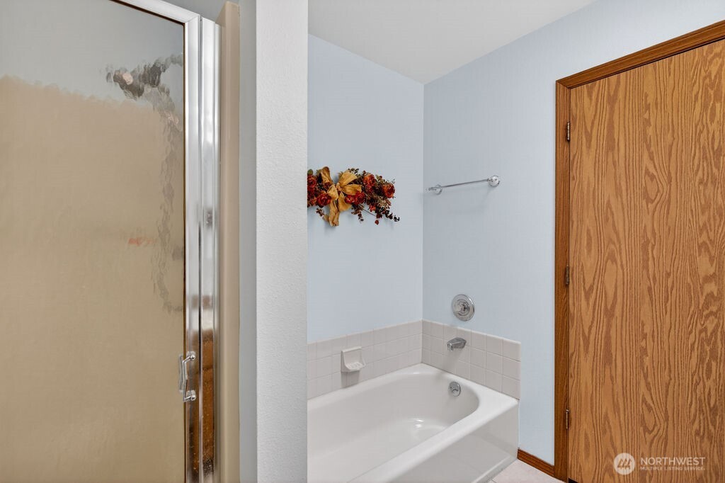 2105 Sutton Place Wenatchee, WA 98801 - Photo 21 of 39 a white bath tub sitting next to a white sink and vanity