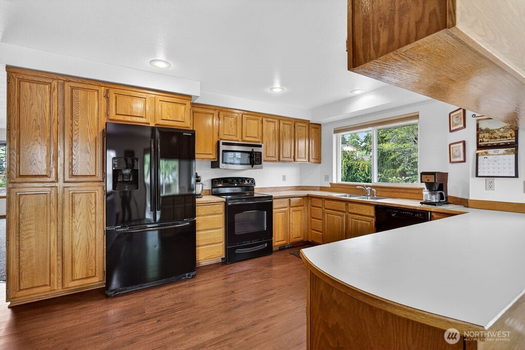 2105 Sutton Place Wenatchee, WA 98801 - Photo 28 of 39 a kitchen with stainless steel appliances a refrigerator and a stove top oven
