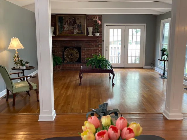 a view of entryway and hall with wooden floor