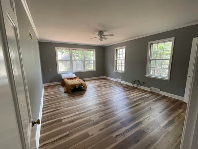 a bedroom with furniture and a window