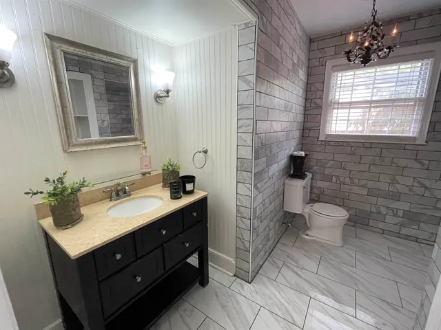 a bathroom with a toilet sink and mirror