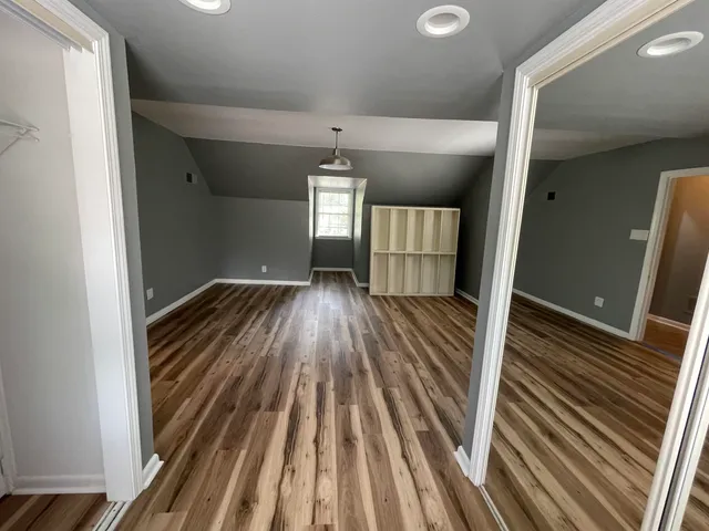 a view of a room with wooden floor