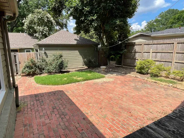 a view of a backyard with a garden and plants