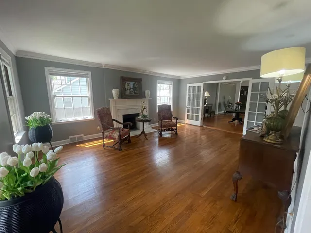 a living room with furniture and a wooden floor