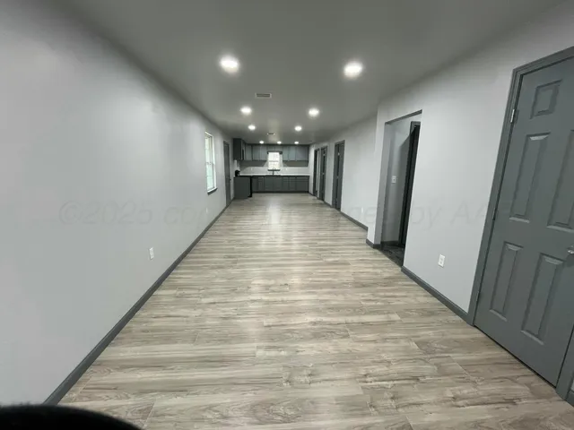 a view of hallway with wooden floor