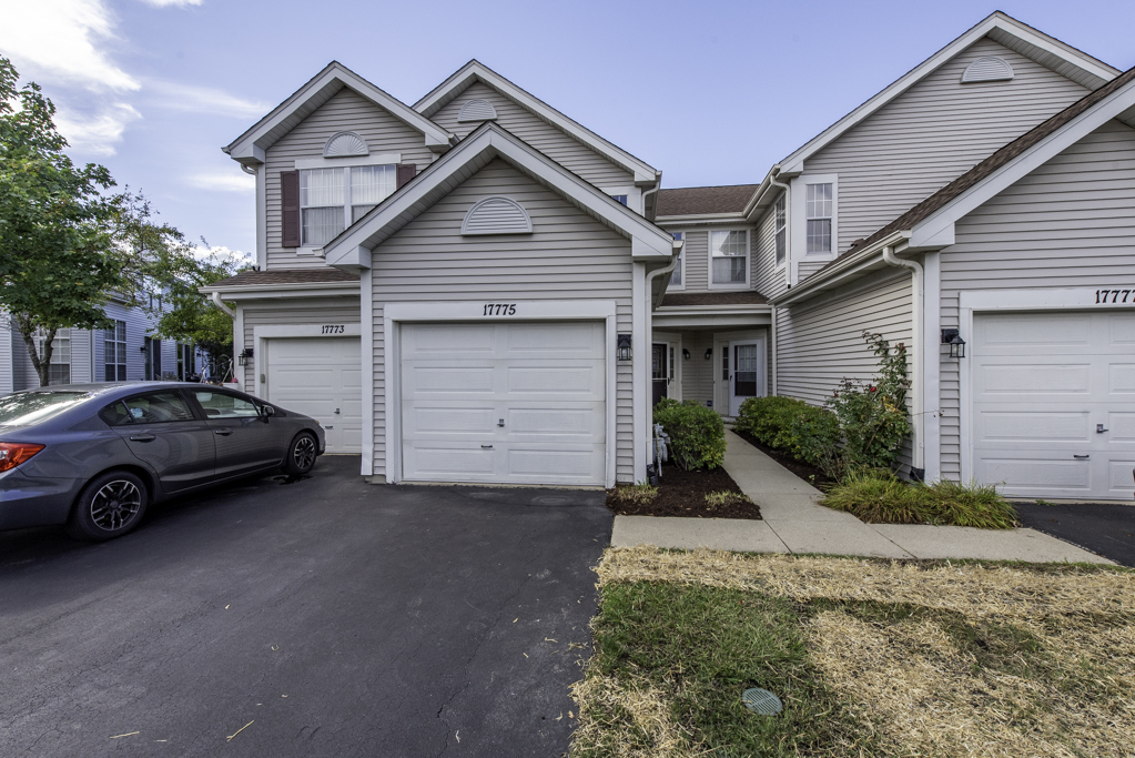 a view of a car parked in front of a house
