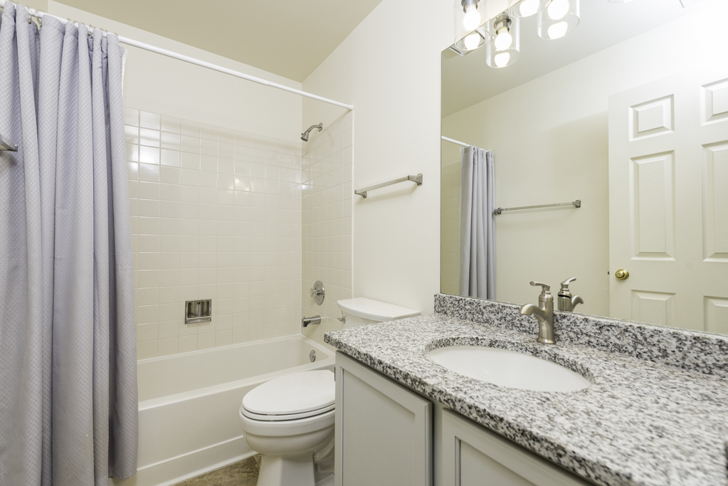 17775 Braewick Road Gurnee, IL 60031 - Photo 16 of 25 a bathroom with a granite countertop sink toilet and shower