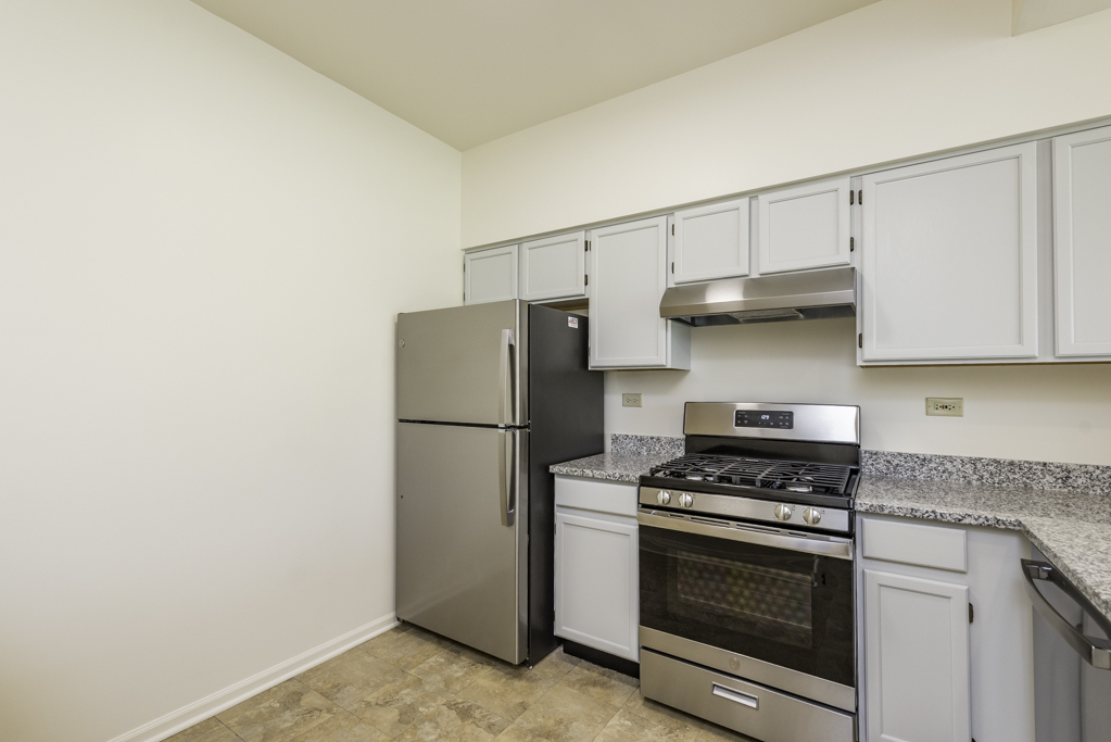 17775 Braewick Road Gurnee, IL 60031 - Photo 18 of 25 a kitchen with stainless steel appliances a refrigerator and a stove top oven