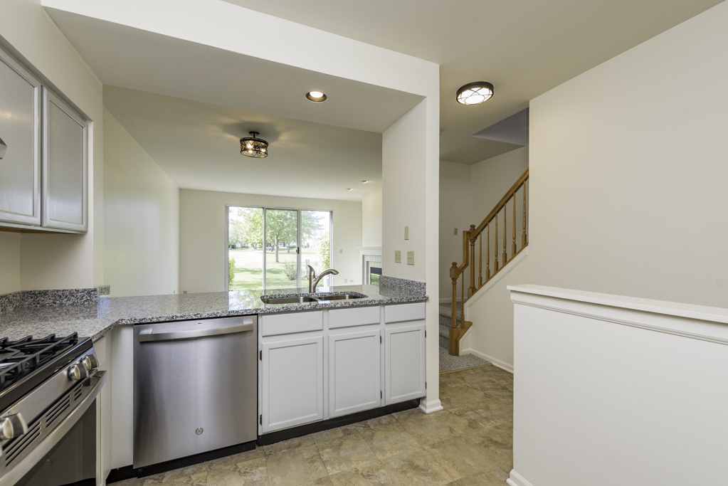 17775 Braewick Road Gurnee, IL 60031 - Photo 19 of 25 a kitchen with a sink cabinets appliances and a window