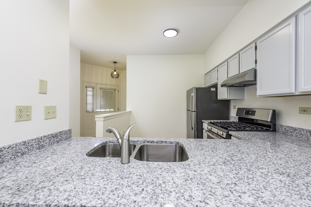 17775 Braewick Road Gurnee, IL 60031 - Photo 21 of 25 a kitchen with stainless steel appliances a sink a stove and a refrigerator with wooden floor