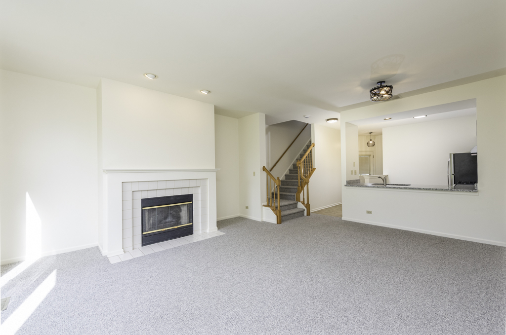 17775 Braewick Road Gurnee, IL 60031 - Photo 22 of 25 a view of an empty room with a fireplace and a window