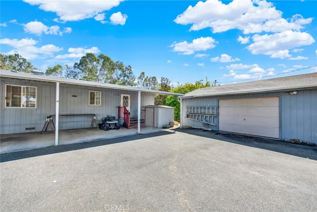 a view of a house with a backyard and garden