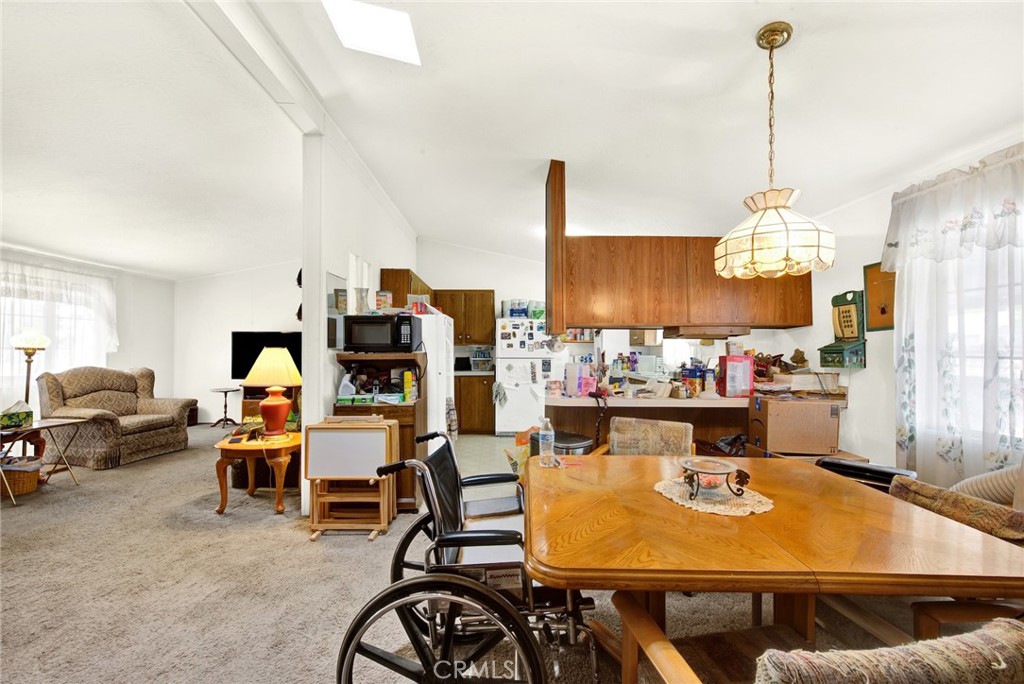 521 East Divisadero Corning, CA 96021 - Photo 34 of 54 a living room with furniture a dining table and chairs with kitchen view