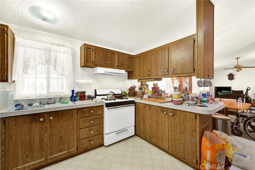 521 East Divisadero Corning, CA 96021 - Photo 36 of 54 a kitchen with a sink a stove and cabinets