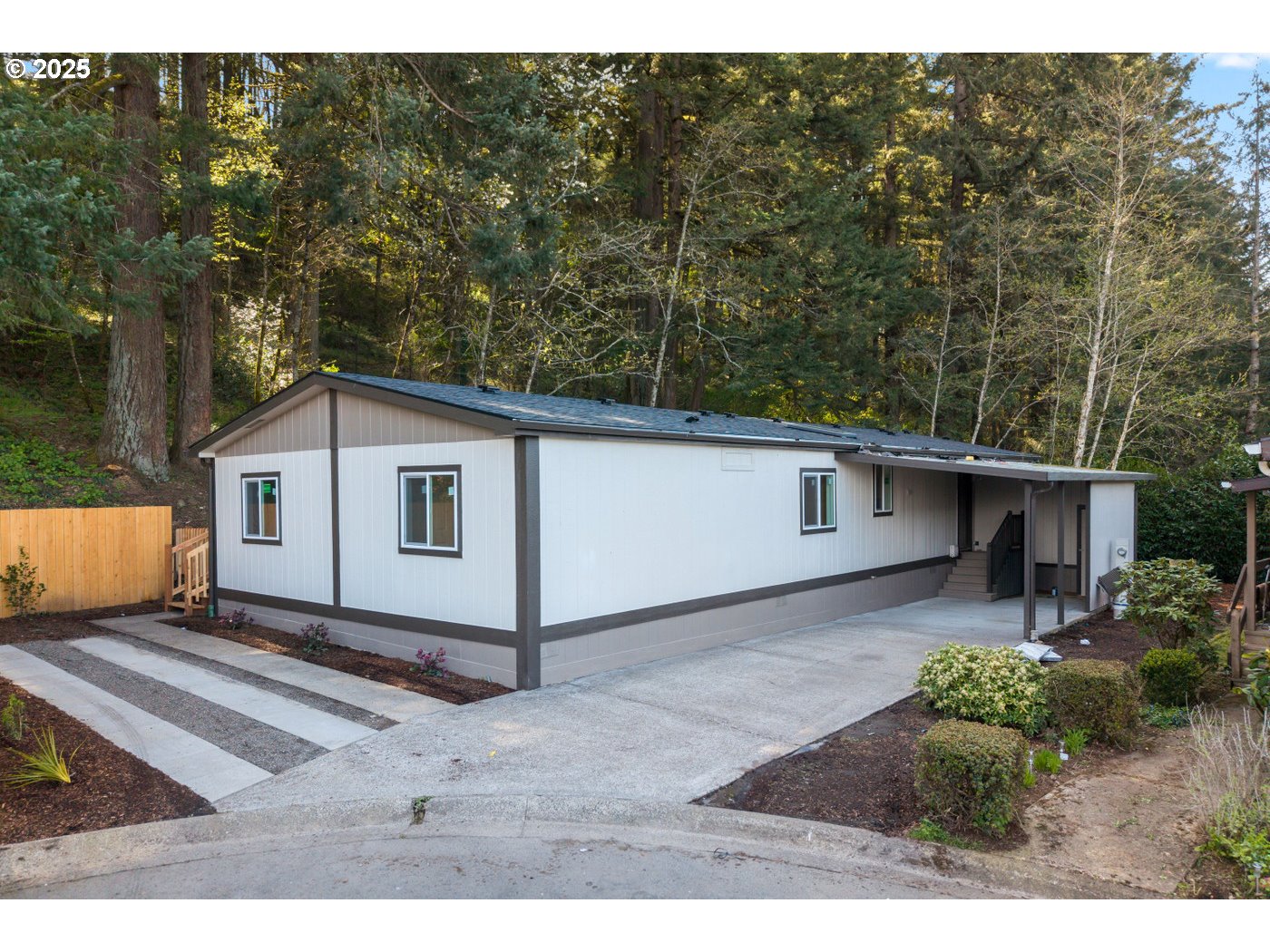 a white house that has a tree in front of it