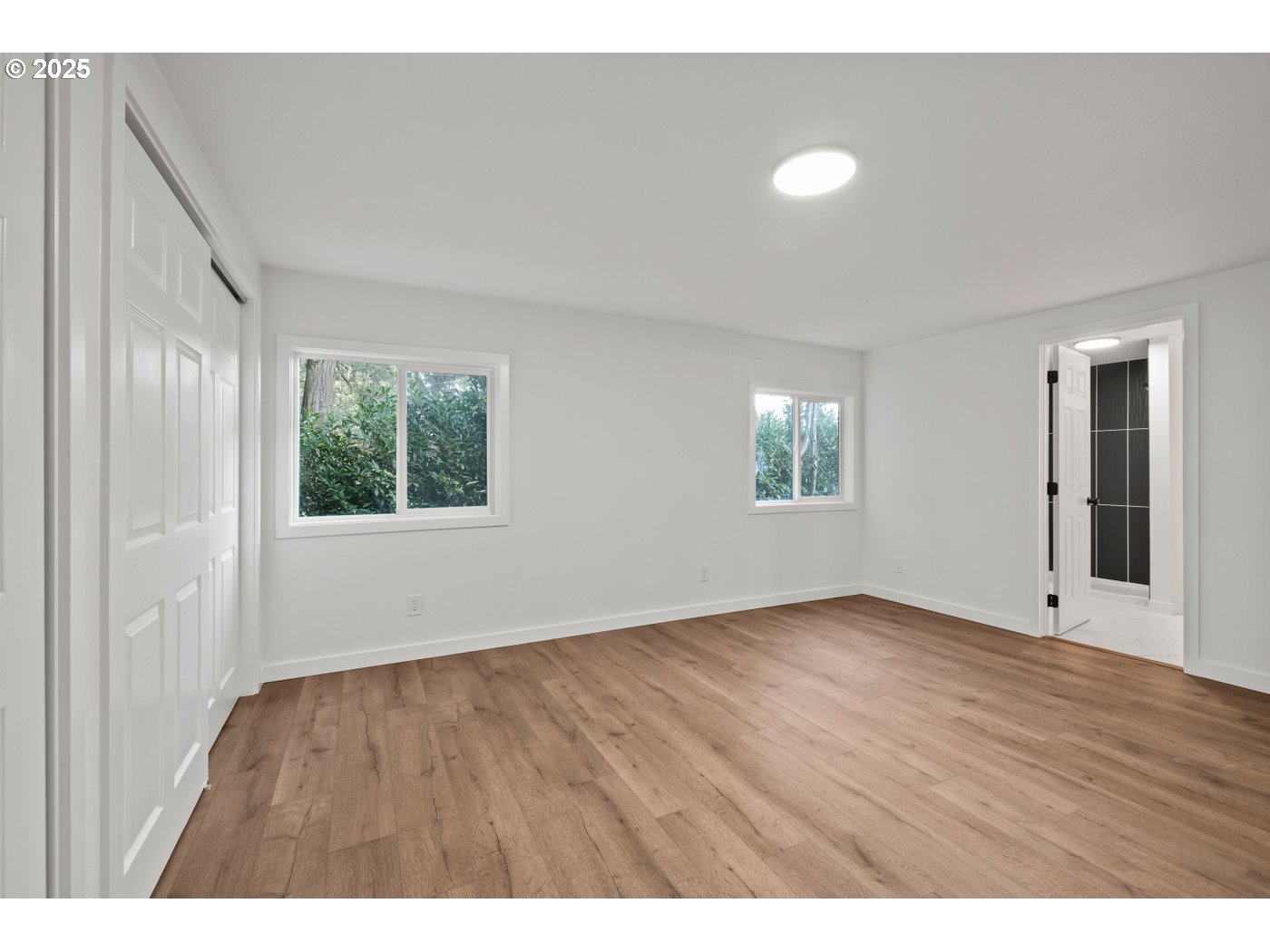 16000 Southeast Powell Boulevard, Unit 34 Portland, OR 97236 - Photo 12 of 28 a view of an empty room with wooden floor and a window