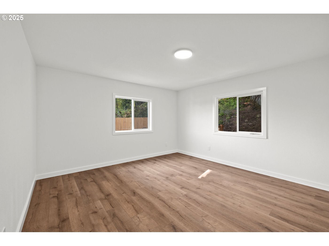 16000 Southeast Powell Boulevard, Unit 34 Portland, OR 97236 - Photo 15 of 28 a view of an empty room with wooden floor and a window