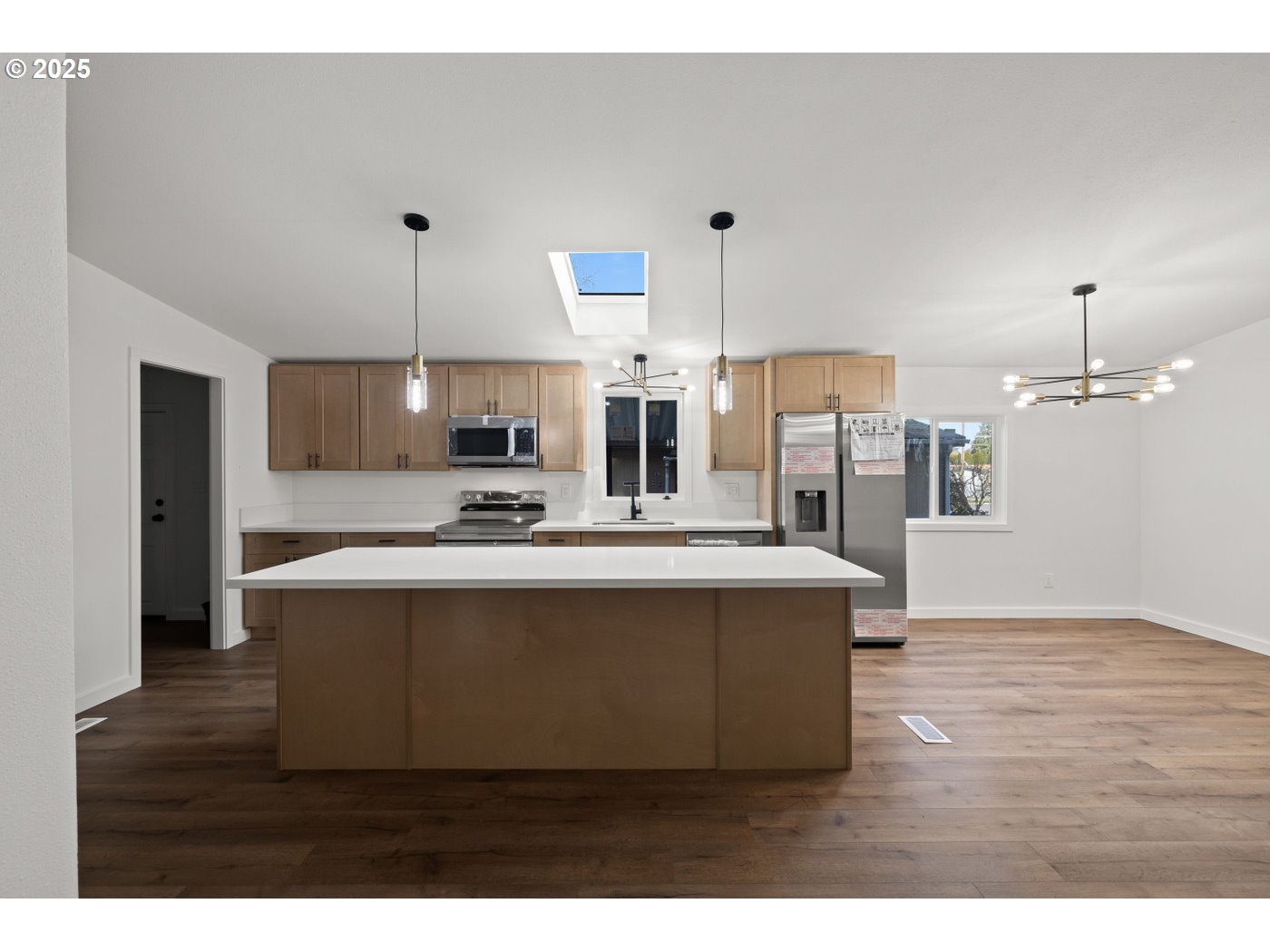 16000 Southeast Powell Boulevard, Unit 34 Portland, OR 97236 - Photo 7 of 28 a view living room with kitchen island stainless steel appliances wooden floor and living room view