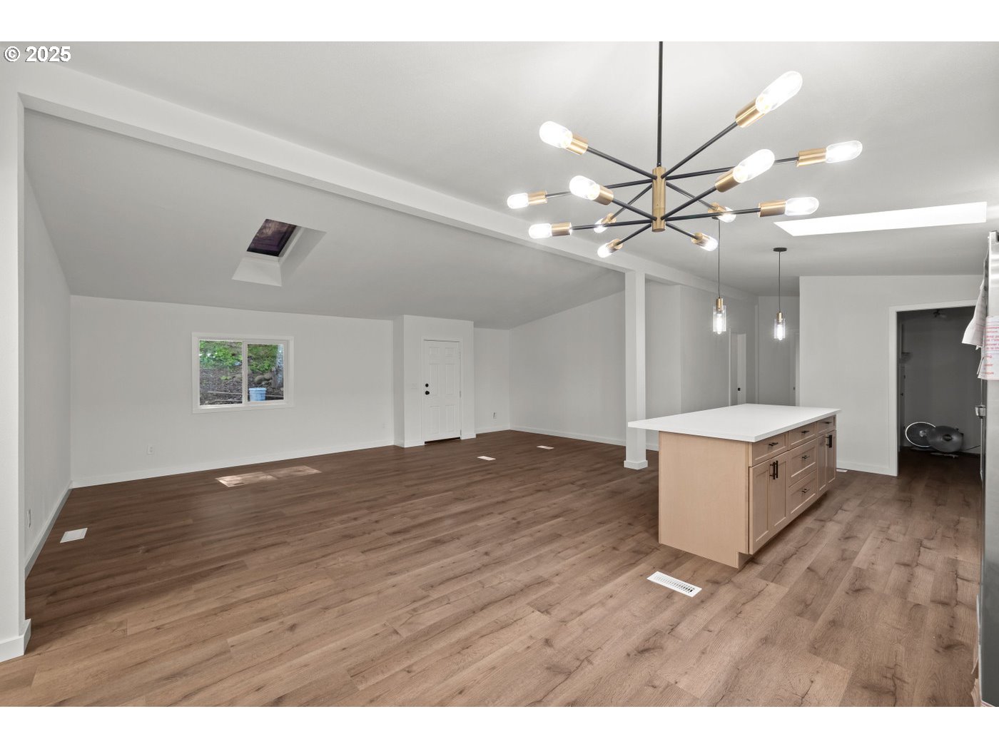 16000 Southeast Powell Boulevard, Unit 34 Portland, OR 97236 - Photo 8 of 28 a kitchen with kitchen island a refrigerator and a wooden floor