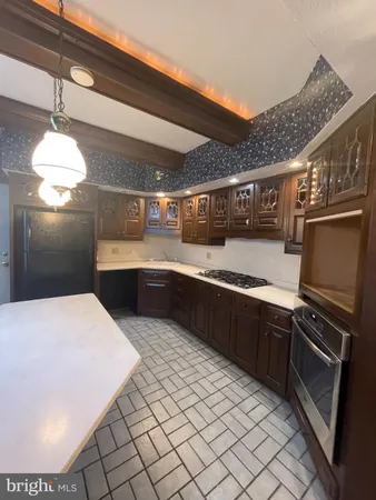 a kitchen with stainless steel appliances granite countertop a sink counter space and cabinets