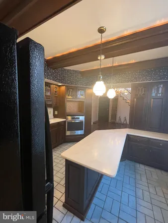 a open kitchen with a sink and refrigerator