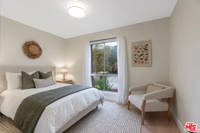 a bedroom with a bed and a couch