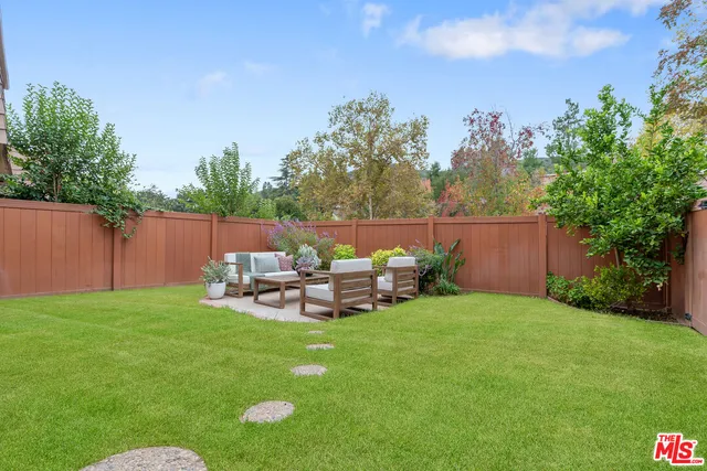 a view of a chair and table in the garden
