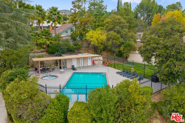 an aerial view of a house with swimming pool garden and patio
