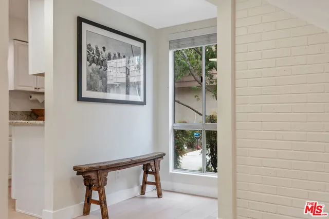 a view of a hallway with furniture and front door