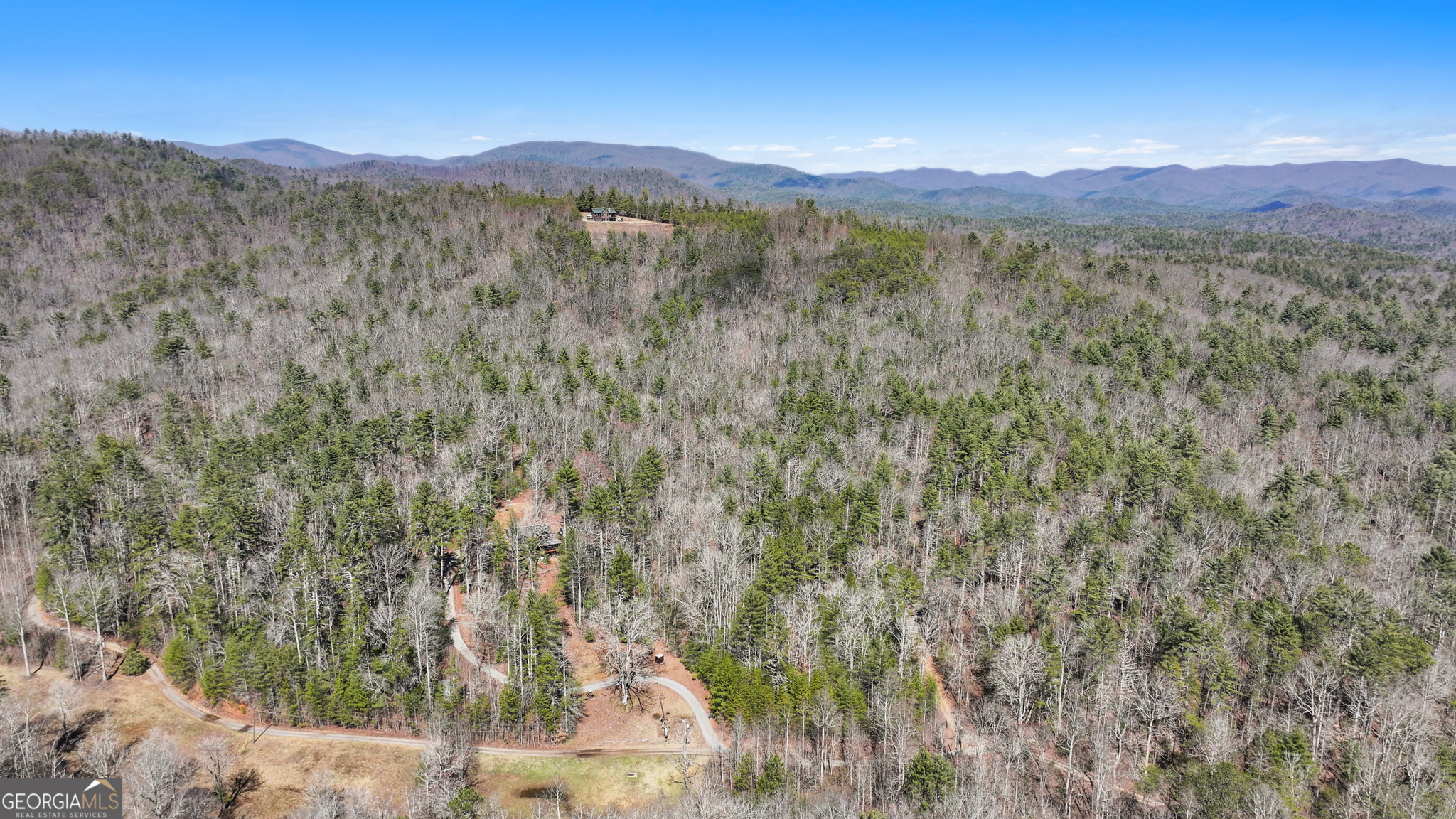 11.1-ac Stevens Ridge Road Ellijay, GA 30540 - Photo 13 of 16 a view of a lush green hillside and a building