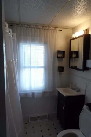 a bathroom with a sink toilet and shower