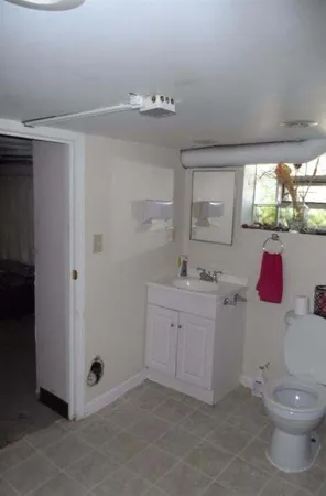 a bathroom with a sink a toilet and mirror