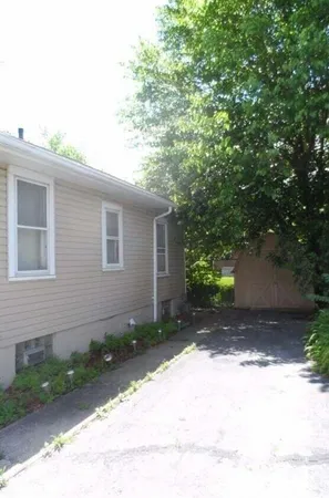 a backyard of a house with plants and trees