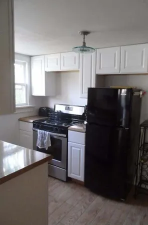 a kitchen with a sink stove and refrigerator