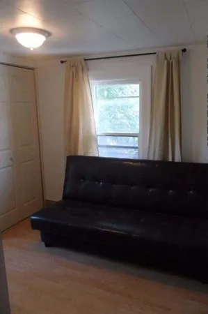a living room with a couch and a window