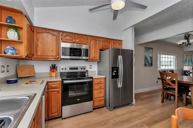 a kitchen with stainless steel appliances granite countertop a refrigerator stove and sink