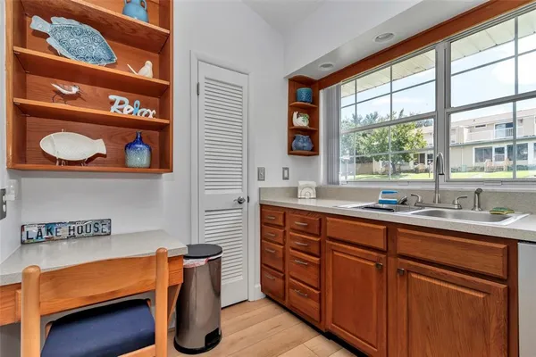 a kitchen with stainless steel appliances granite countertop a sink and a window
