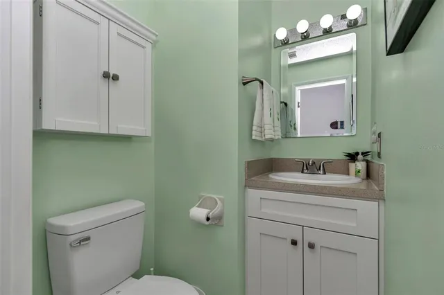 a bathroom with a sink vanity and mirror