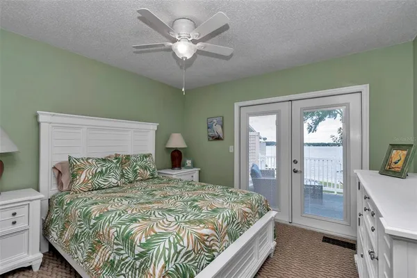 a bedroom with a large bed and a chandelier