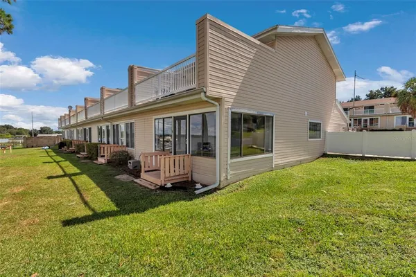 a view of a house with a yard and a patio