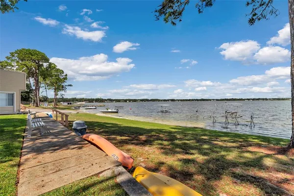 a view of a swimming pool and an outdoor seating