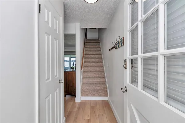 a view of a hallway with wooden floor and entryway