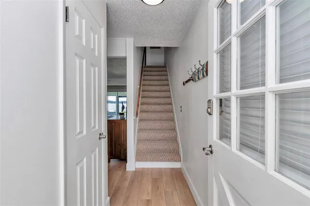 a view of a hallway with wooden floor and entryway