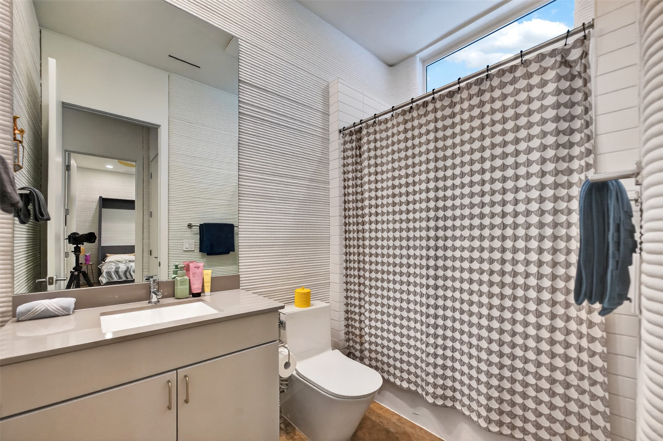 308 Painted Sunset Drive Georgetown, TX 78628 - Photo 14 of 26 Bathroom featuring textured wall tile, a window above the shower, a single vanity with an integrated sink, and a large wall mirror
