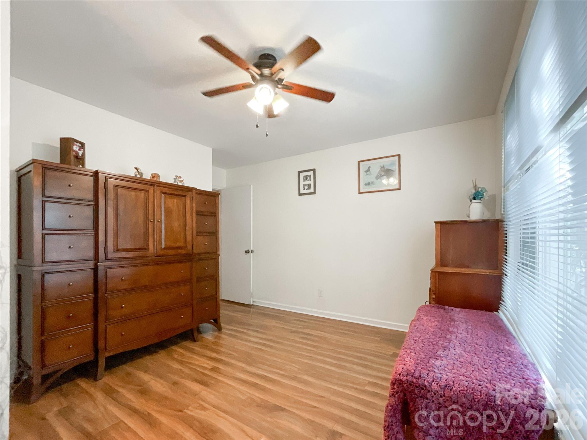 7200 Nesbit Road Waxhaw, NC 28173 - Photo 14 of 46 a bedroom with a bed and a chandelier