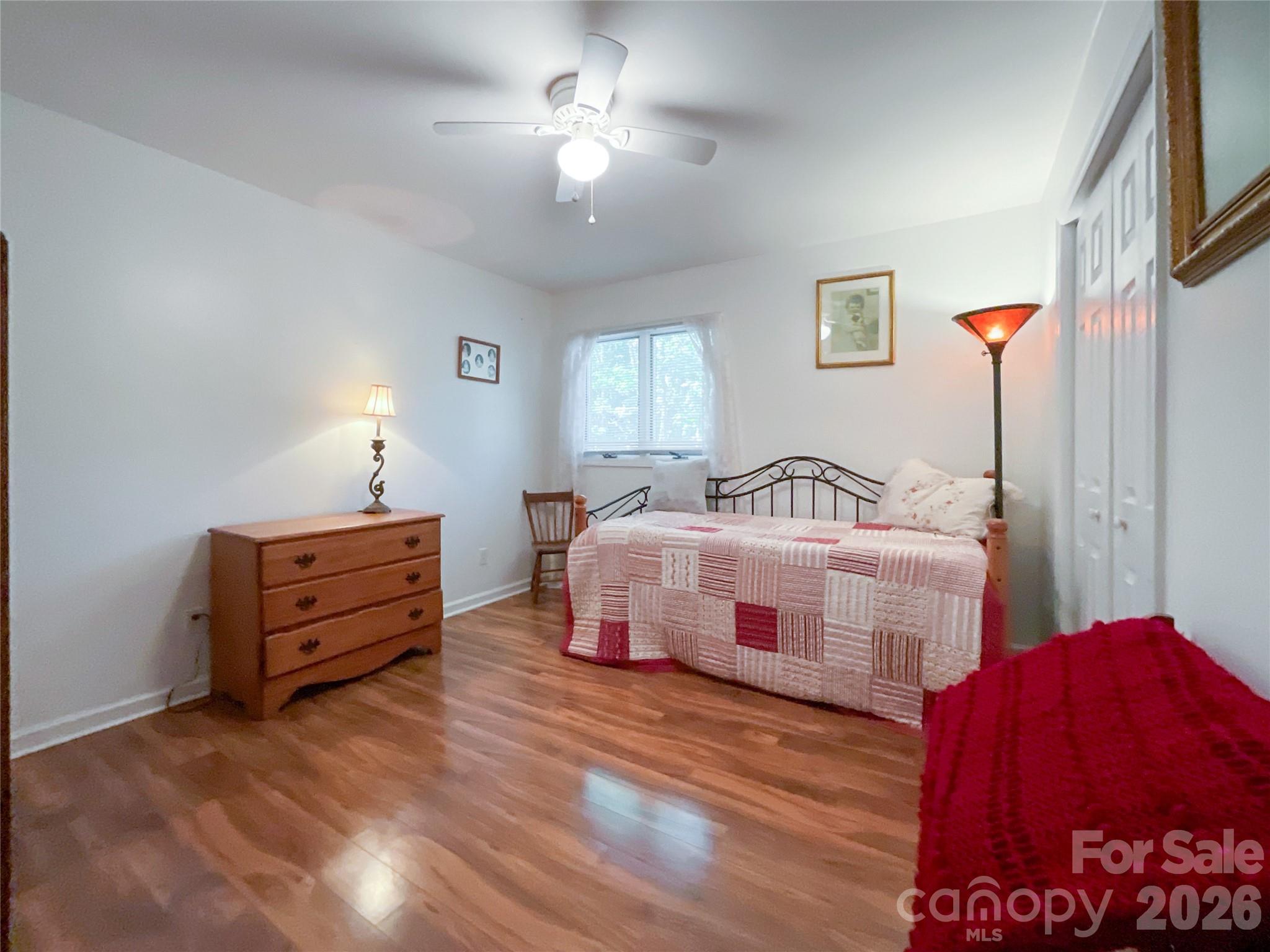 7200 Nesbit Road Waxhaw, NC 28173 - Photo 18 of 46 a bedroom with a bed and a chandelier
